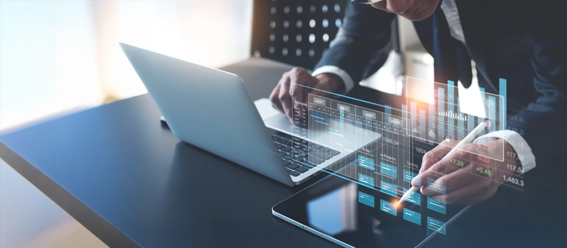 person working on a computer displaying graphs and data for fpsl forecasting, planning and simulation 
