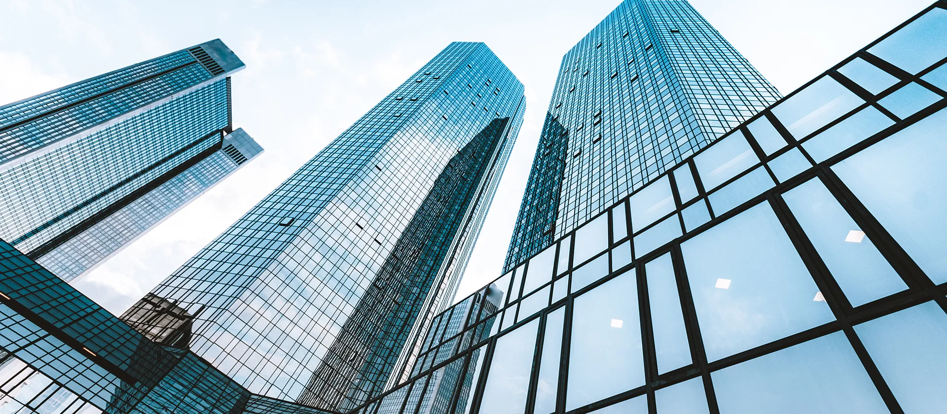 Modern glass skyscrapers reflecting sky in business district, symbolizing corporate growth and innovation
