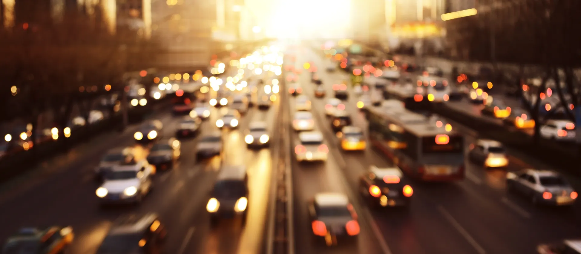 Visual for msg.AMI Augmented Mobility Index showing heavy city traffic at sunset with blurred headlights and taillights during evening rush hour