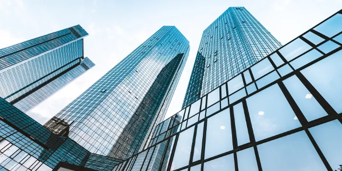 Modern glass skyscrapers reflecting sky in business district, symbolizing corporate growth and innovation
