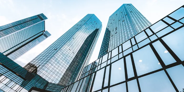 Modern glass skyscrapers reflecting sky in business district, symbolizing corporate growth and innovation