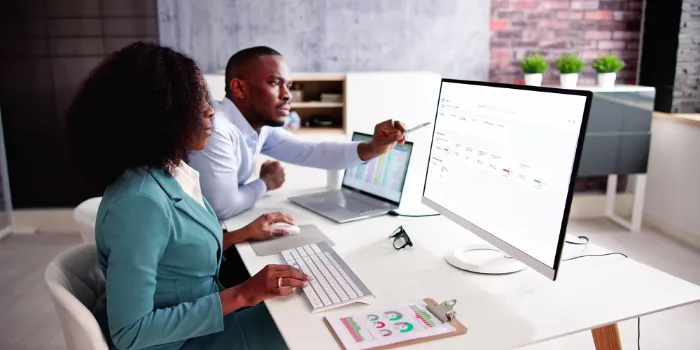 Two business professionals analyzing sustainability data from SAP sustainability control tower on a computer screen