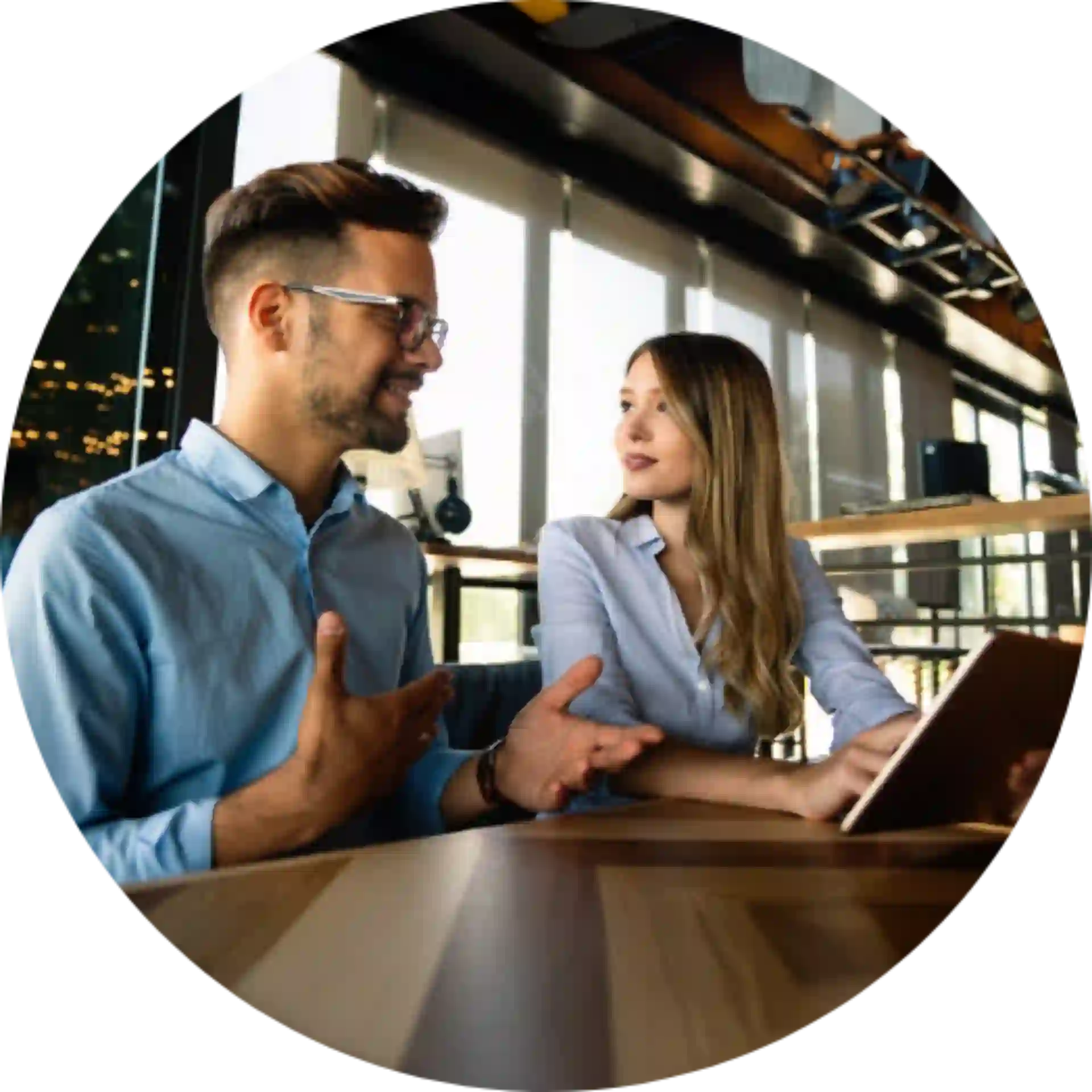Two professionals in a business setting with a laptop collaborating and discussing ai and advanced analytics strategy