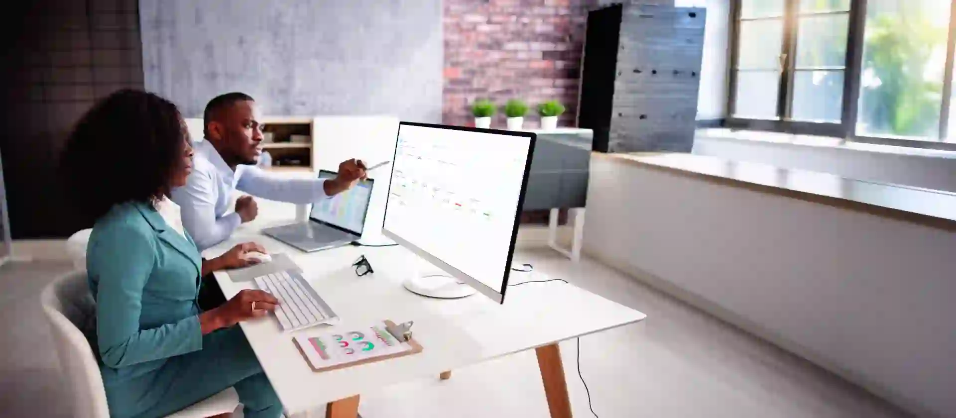 Two business professionals sustainability analyzing data on from sap sustainability control towner on a  computer screen